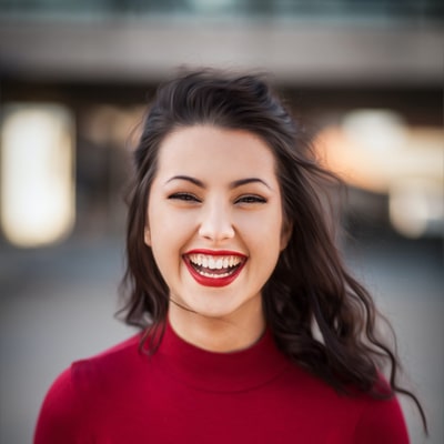 Female client smiling in a testimonial image, expressing satisfaction with her experience at JF Property Group, highlighting exceptional customer service and successful real estate transactions