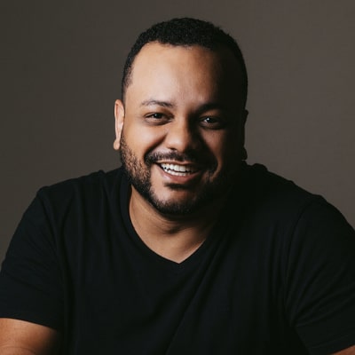 Male client smiling in a testimonial image, sharing a positive experience with JF Property Group, emphasizing excellent customer service and successful real estate transactions